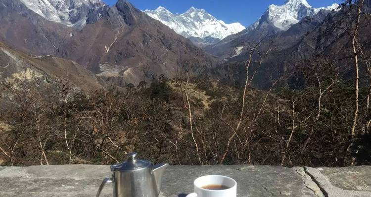 View of mountains with a coffee setup in the foreground.