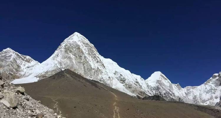 Snow-covered mountain under a clear blue sky.