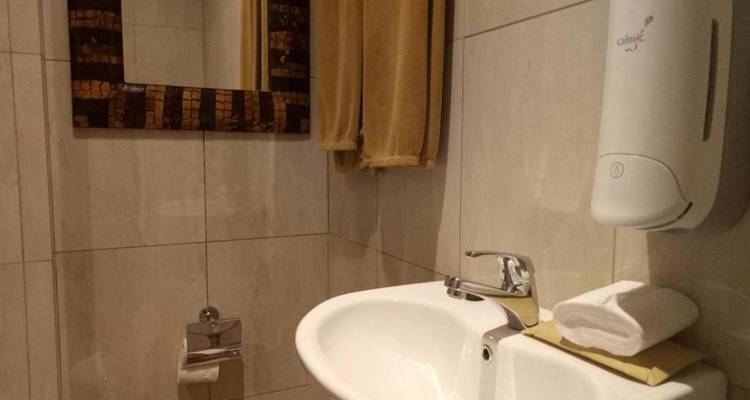 Basic bathroom with sink and mirror.