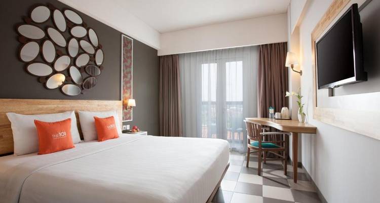 Stylish hotel room with a large window and modern design.