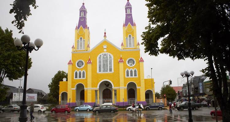 Colorful cathedral with twin towers in the rain.