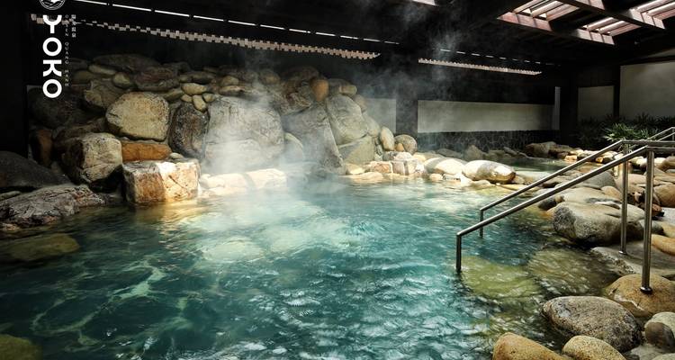 Indoor hot spring with steam rising.