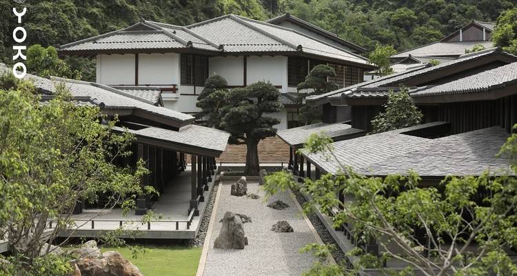 Traditional Japanese-style architecture in a garden setting.