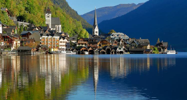Charming village by a lake with mountain reflections.