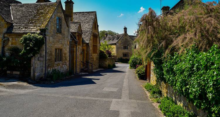 A historical village street lined with stone buildings.