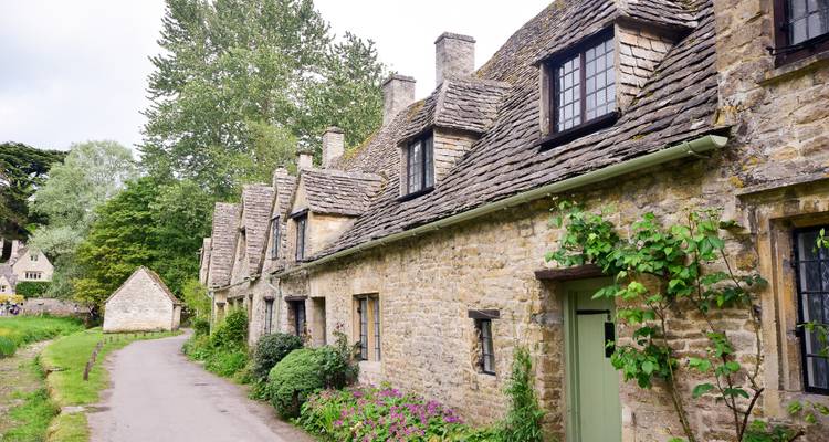Row of charming old cottages made of stone.