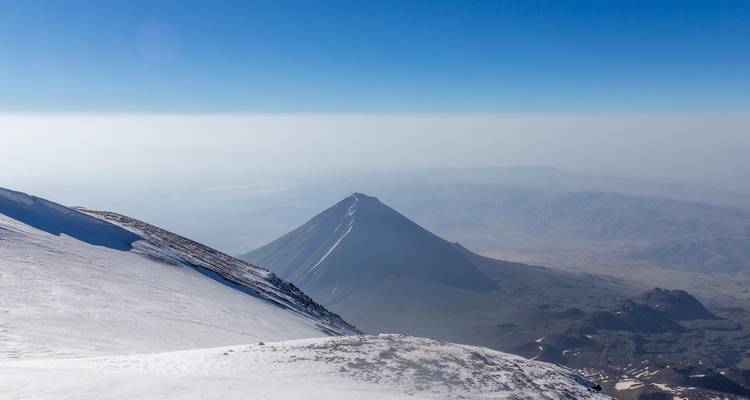 Mountain peak and landscape from a high snowy summit.