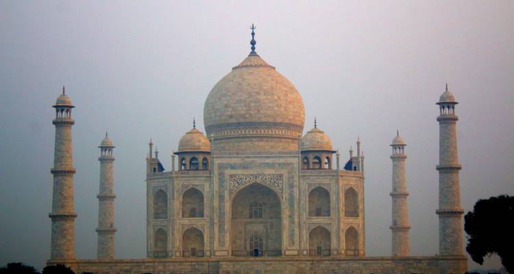 The Taj Mahal silhouetted against a colorful sky.