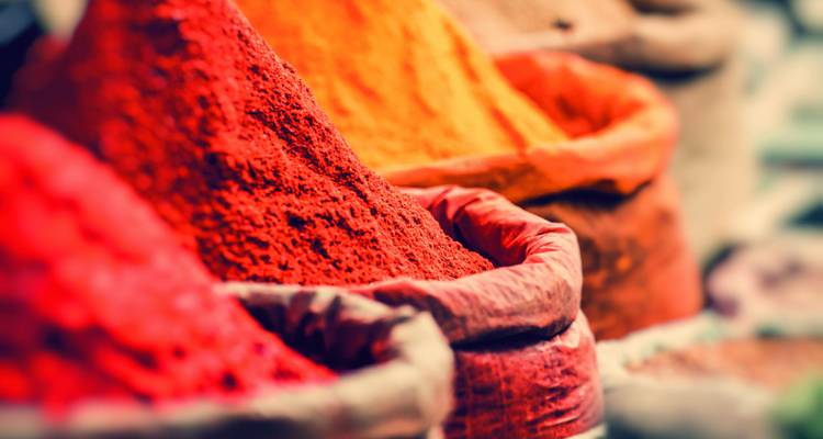 Close-up of colorful spice bags at a market.