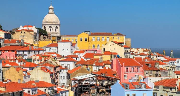A view of a city with domed buildings and red rooftops.