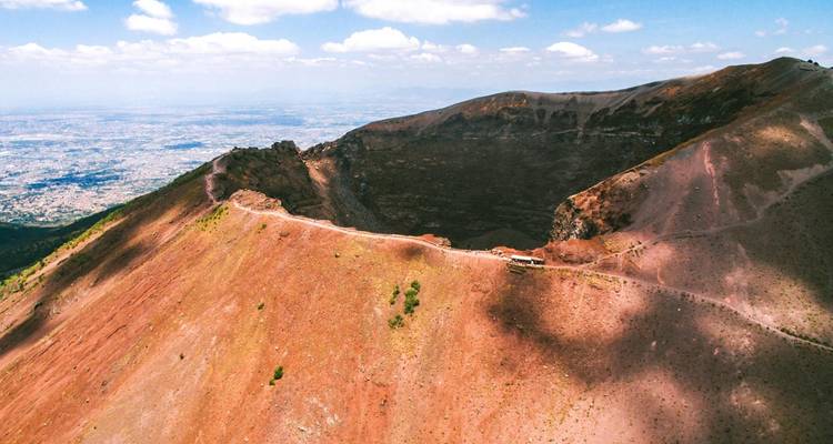 View of Mount Vesuvius crater in a clear, sunny landscape.