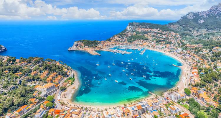 Aerial view of a coastal town with turquoise water.