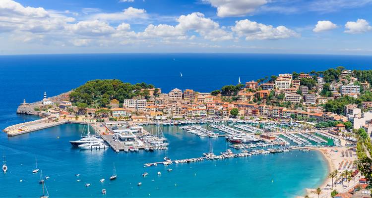 Picturesque marina with yachts and blue seas.
