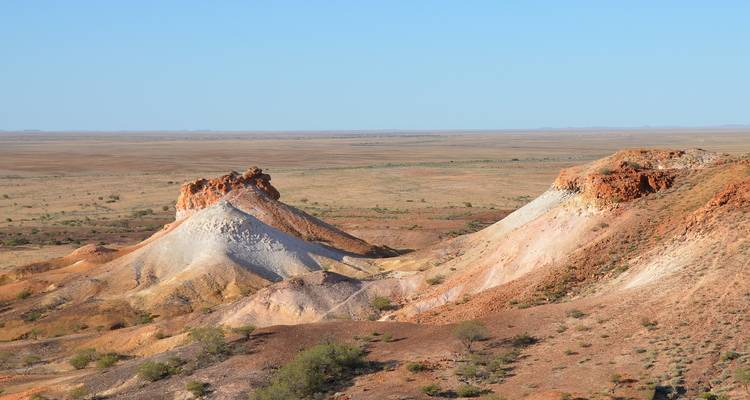 A barren desert landscape with unique rock formations.