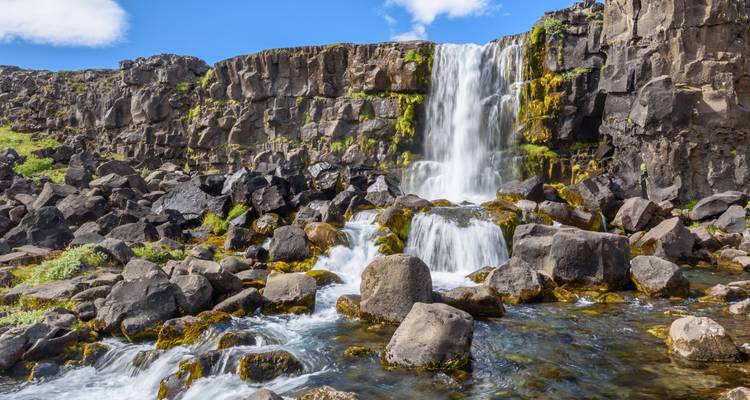 Beautiful waterfall cascading over lush moss-covered rocks.
