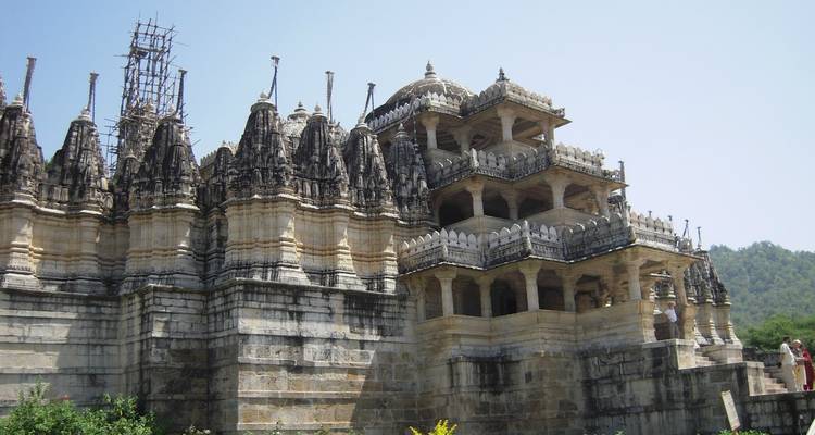 Ornate temple complex with multiple spires and people exploring.