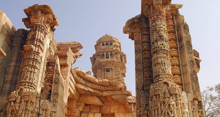 Ancient temple ruins with detailed carvings under a clear sky.