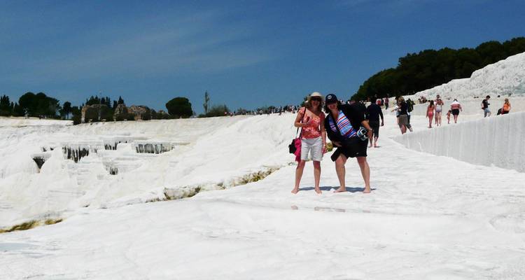 White terraces filled with water and people walking.