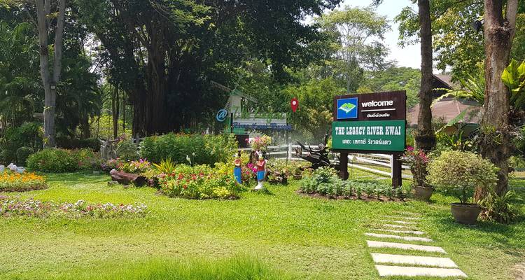 Ein Uferpark mit einem Willkommensschild und üppigem Grün.