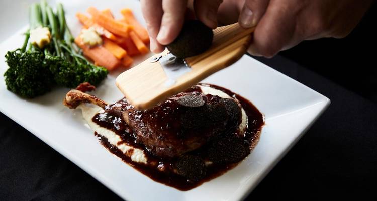 Plat de canard gastronomique garni de truffe râpée