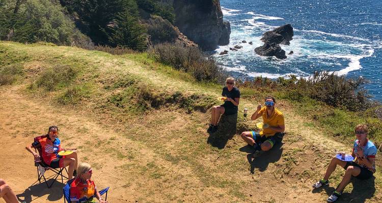 Group of people enjoying a picnic by the coast.