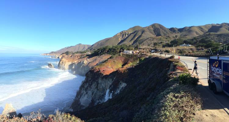 Coastal view with cliffs and waves crashing below.