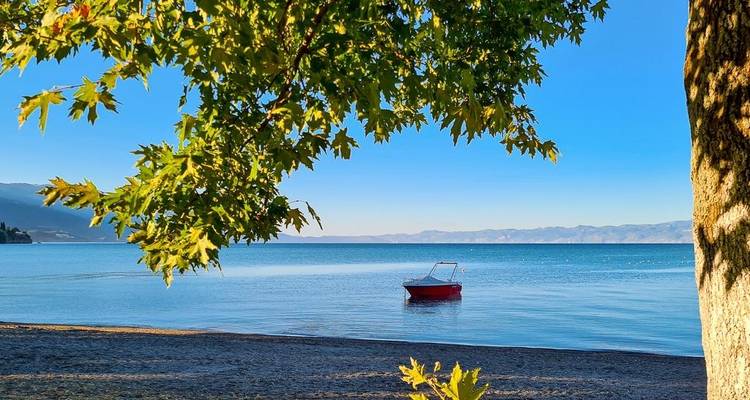 Scenic view of a boat on a lake with mountains in the background.