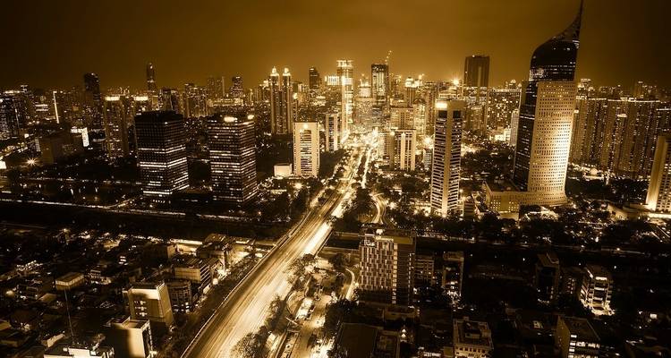 Night skyline of Jakarta with brightly lit buildings.