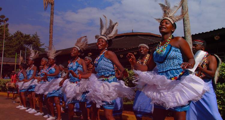 Traditional dancers in colorful costumes performing outdoors.