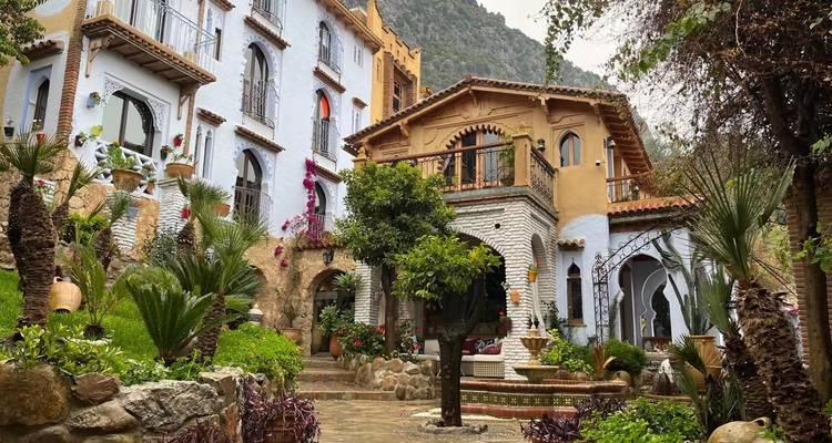 Colorful and ornate building with lush greenery around.