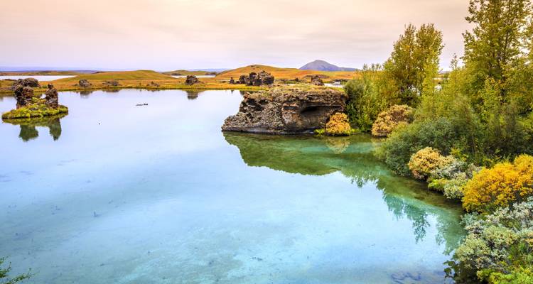 Schilderachtig uitzicht over het meer met vulkanische rotsformaties and begroeiing.