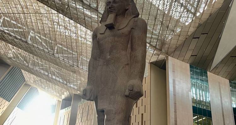 Giant statue in a modern museum setting.