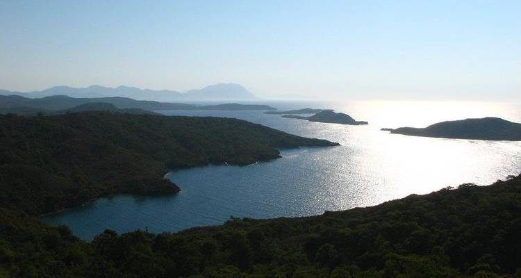 A panoramic view of a coastal landscape with islands and water.