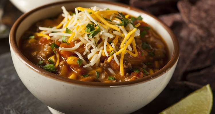 Bowl of chili with cheese and vegetables