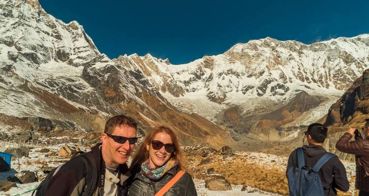 Couple posing with a snowy mountain range.