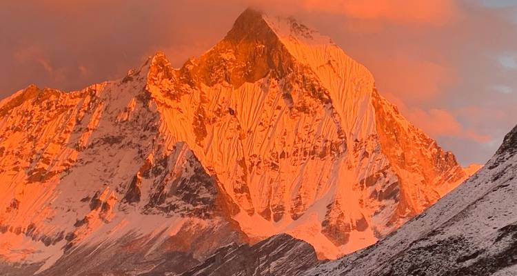 Close-up of mountain peak glowing at sunset.