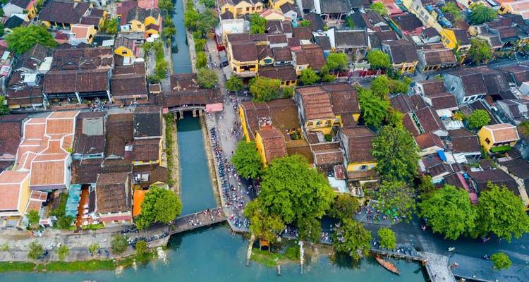 Aerial view of an ancient town with canals and historic architecture.