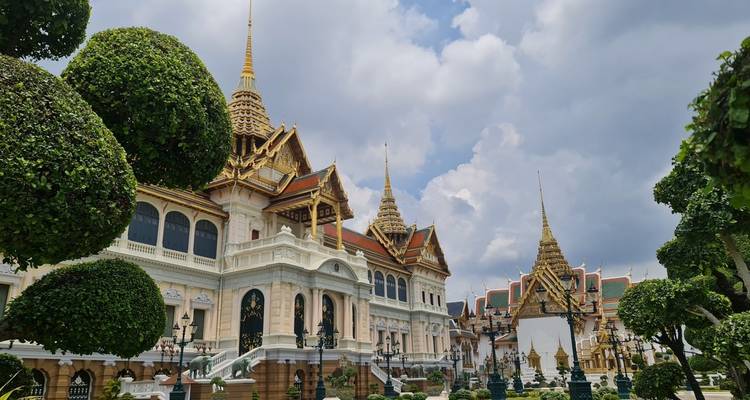 Temple complex with green gardens and traditional architecture.