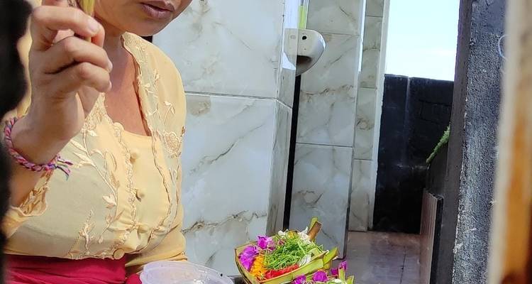 Person preparing a flower offering.