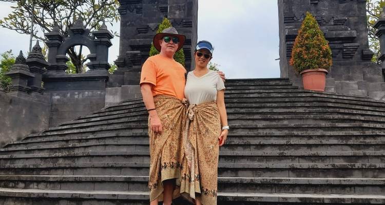Couple standing on temple stairs in traditional clothing