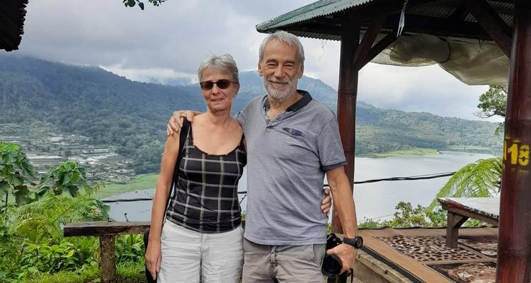Couple posing with a scenic lake and mountains