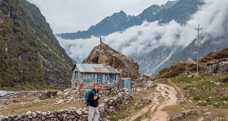 Wanderer geht auf einem Pfad in einem üppigen Berggebiet.