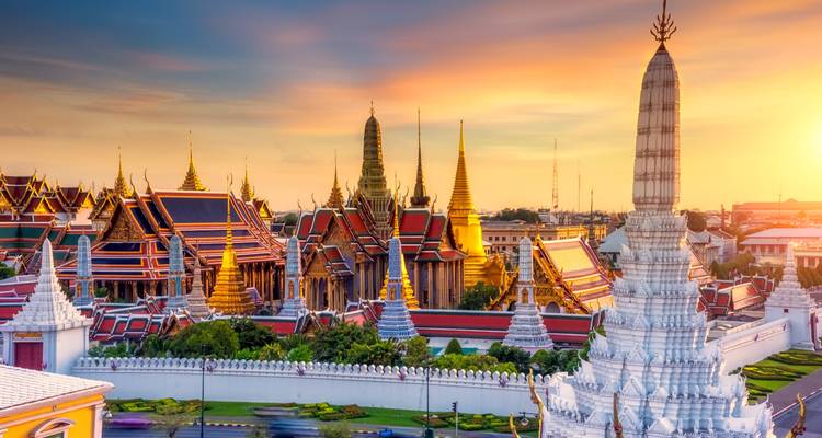 Panoramic view of a temple complex during sunset with golden light.