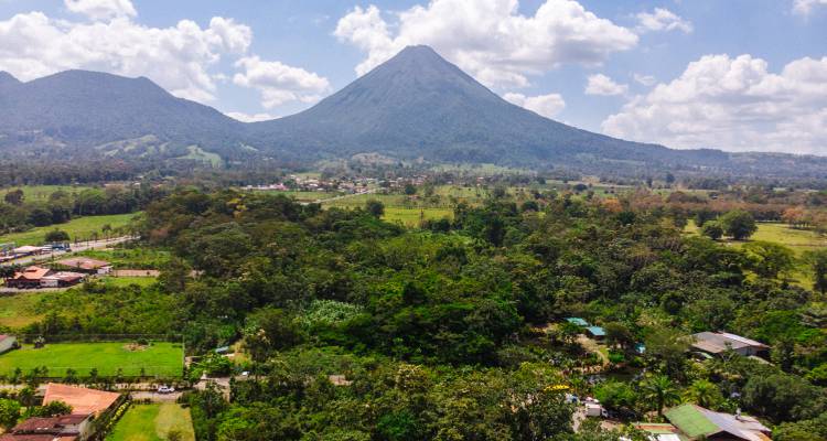 Aerial view of countryside with a prominent volcano.