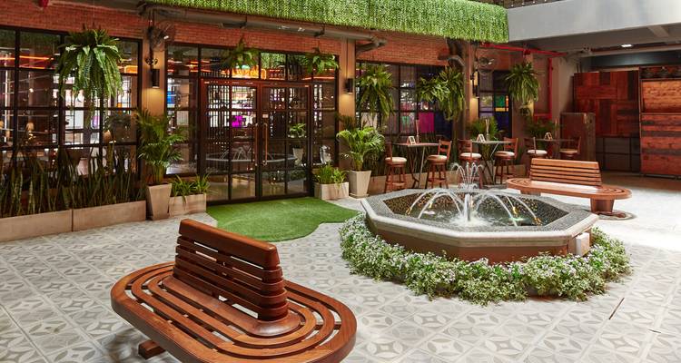 A courtyard with a water fountain and benches.