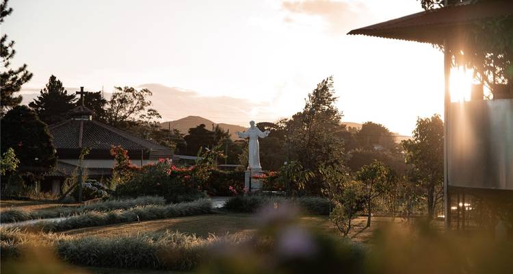 Jardín con una estatua durante el atardecer.