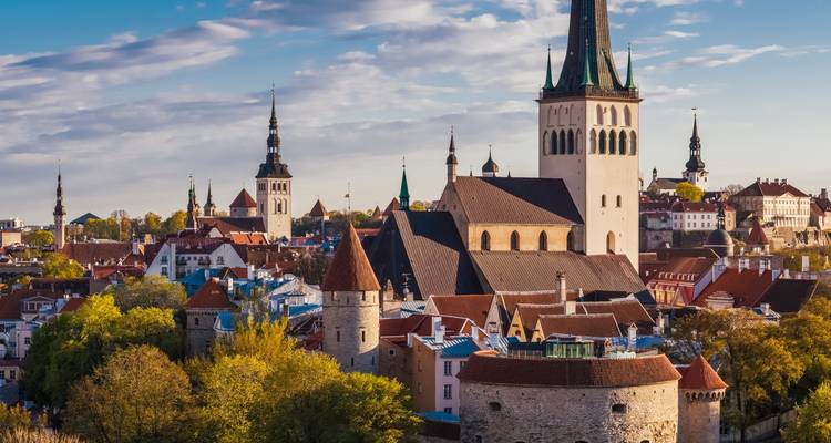 Panoramic cityscape with church spires and historic buildings.