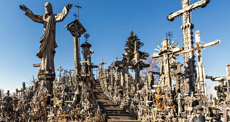 Hill of Crosses with numerous wooden crosses and statues.