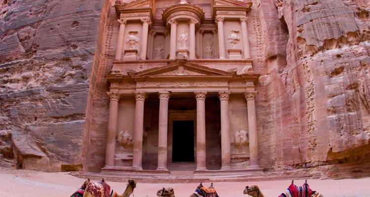 Iconic Petra Treasury facade with camels in the foreground.