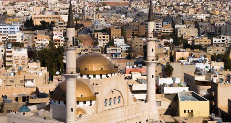 Stadsgezicht met een moskee met gouden koepels.
